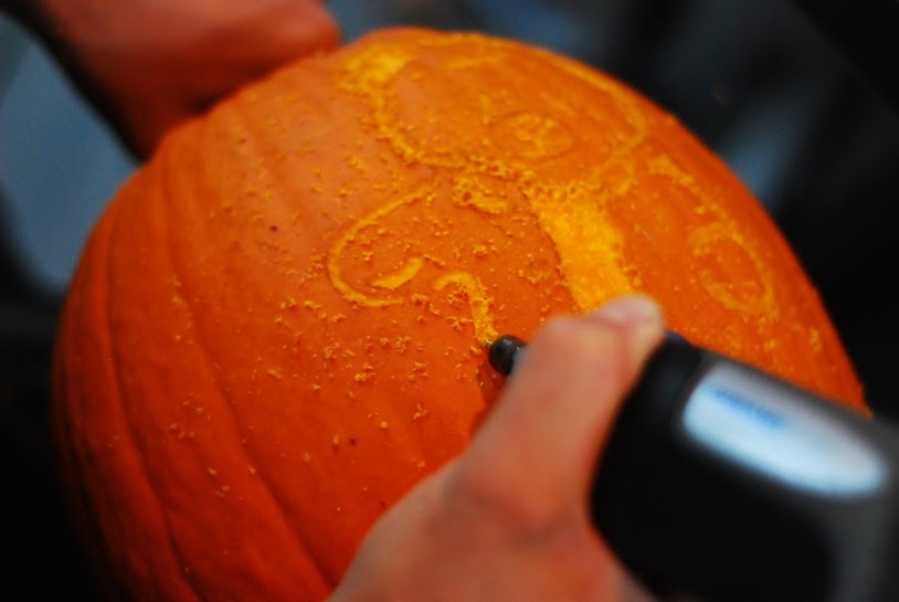 Rotary tool being used to carve a pumpkin